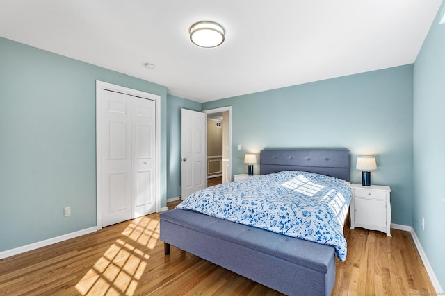 bedroom with a closet and light hardwood / wood-style floors