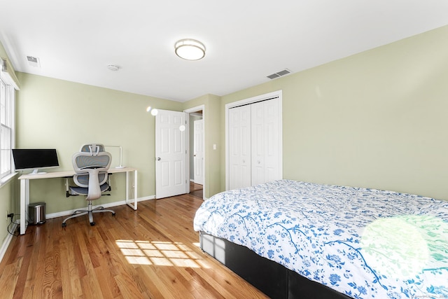 bedroom featuring hardwood / wood-style flooring and a closet