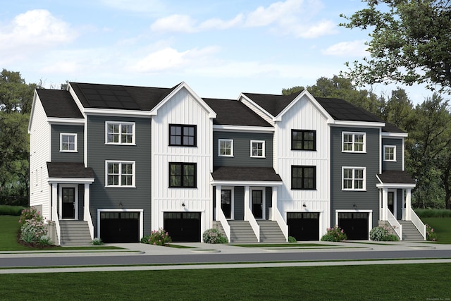 view of front facade with a front yard and a garage