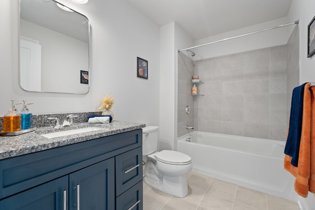 full bathroom featuring toilet, tile patterned flooring, vanity, and tiled shower / bath