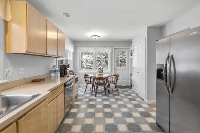 kitchen featuring appliances with stainless steel finishes and light brown cabinetry