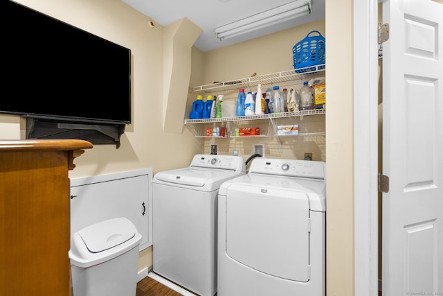 laundry room featuring independent washer and dryer and hardwood / wood-style floors