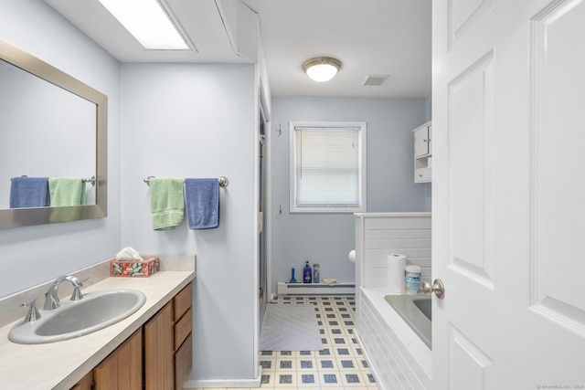 bathroom with vanity and a tub to relax in