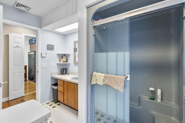 bathroom with vanity and hardwood / wood-style flooring