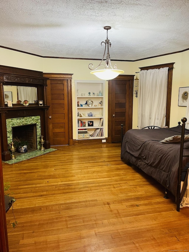 bedroom with hardwood / wood-style floors and a textured ceiling