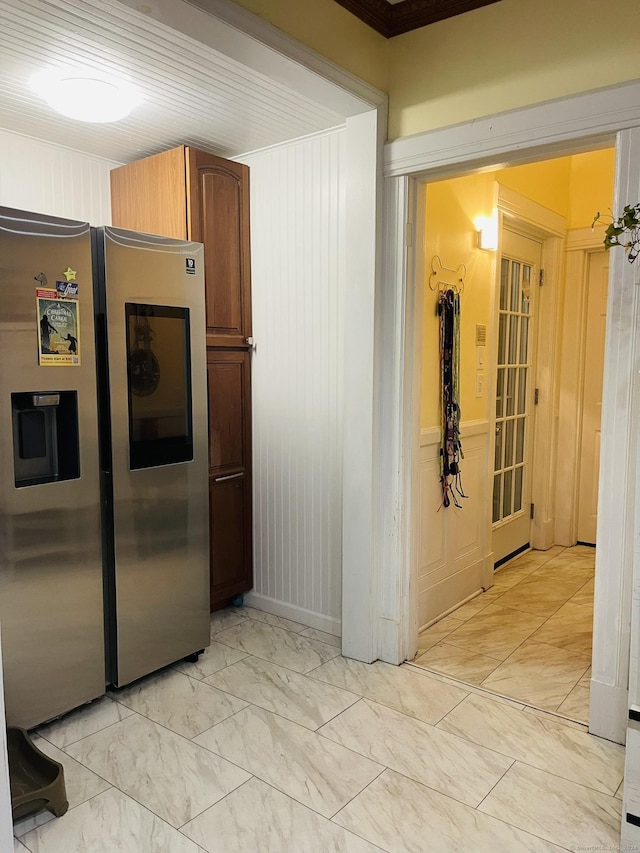 kitchen featuring crown molding and stainless steel refrigerator with ice dispenser