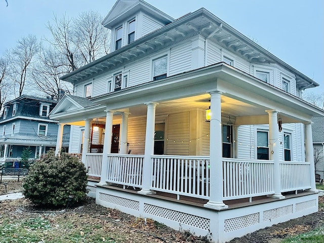 view of side of property featuring covered porch