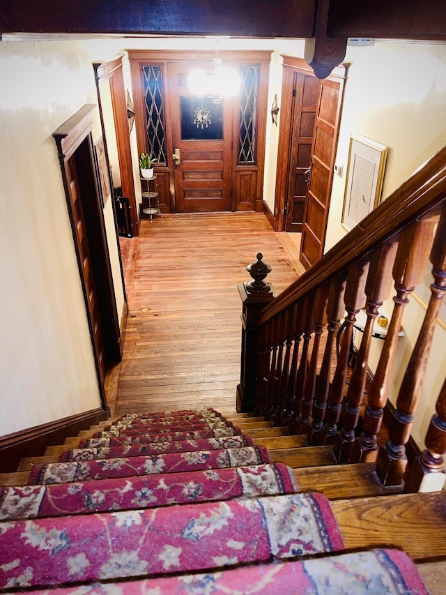 staircase with wood-type flooring