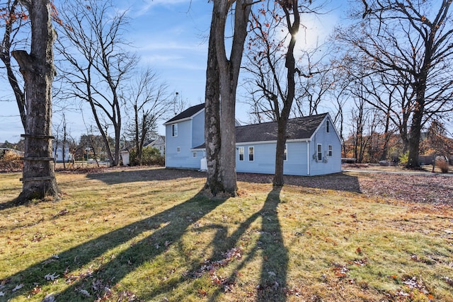 view of side of home with a lawn