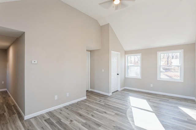 unfurnished room with ceiling fan, high vaulted ceiling, and light hardwood / wood-style floors