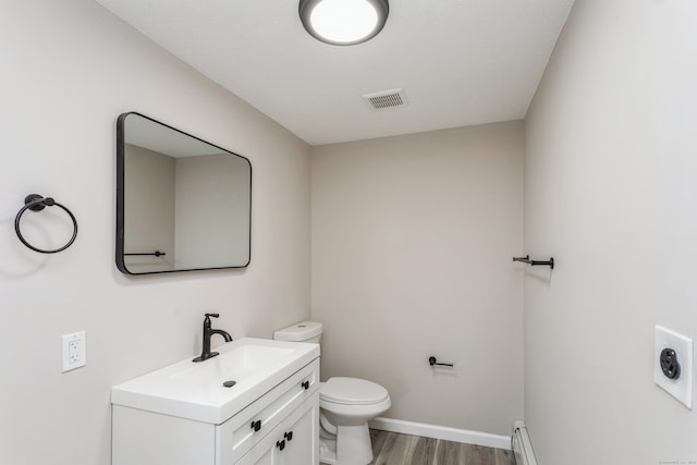 bathroom featuring hardwood / wood-style flooring, vanity, and toilet