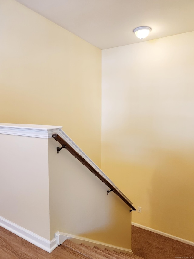 stairs featuring hardwood / wood-style floors