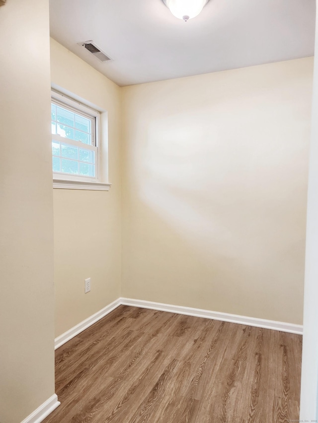 spare room with wood-type flooring