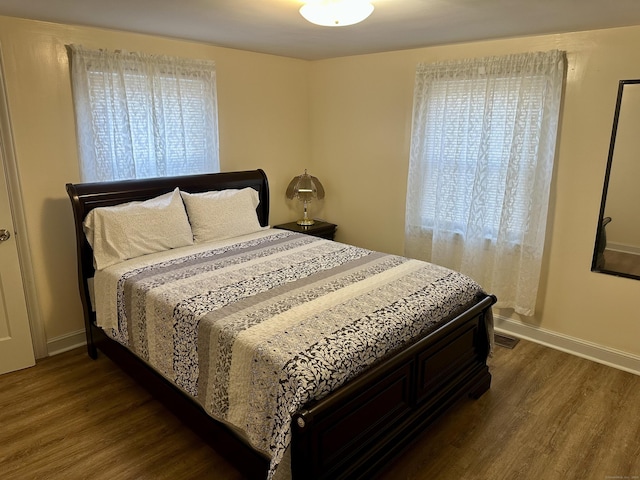 bedroom with dark wood-type flooring