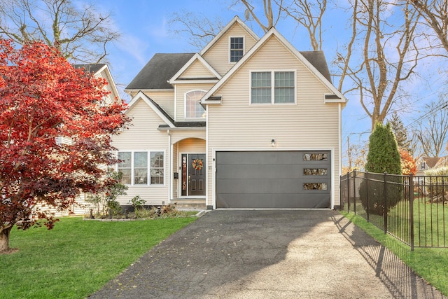 view of front of home featuring a front yard and a garage