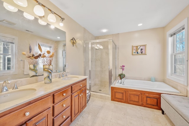 bathroom featuring vanity, plenty of natural light, and plus walk in shower