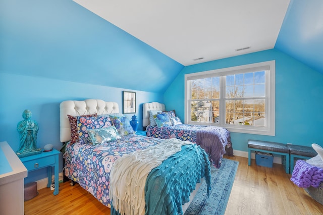 bedroom featuring light hardwood / wood-style flooring and vaulted ceiling