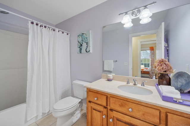 full bathroom with tile patterned floors, shower / bathtub combination with curtain, vanity, and toilet