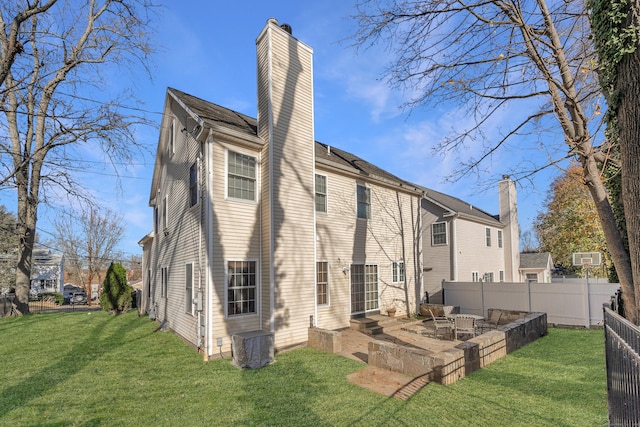 back of house featuring a lawn and a patio