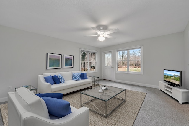 carpeted living room with ceiling fan