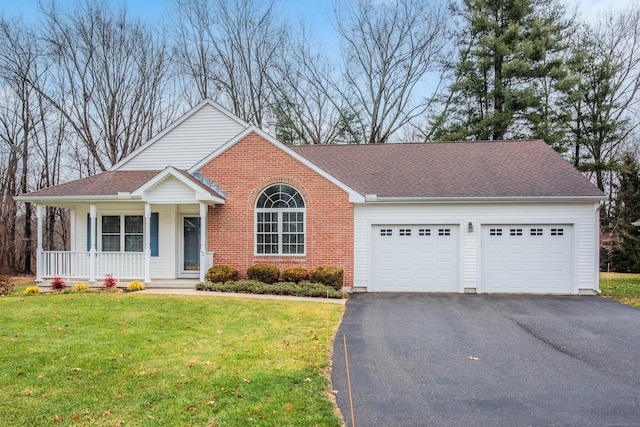 view of front of house with a porch, a garage, and a front yard