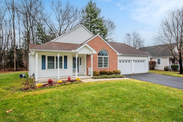 view of front of property with a front lawn, a porch, and a garage