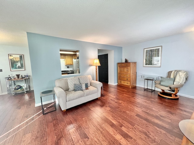 living room featuring hardwood / wood-style floors and a textured ceiling