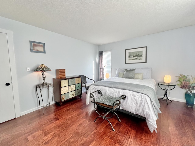 bedroom with wood-type flooring and a textured ceiling