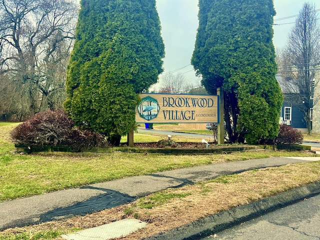 community / neighborhood sign with a lawn