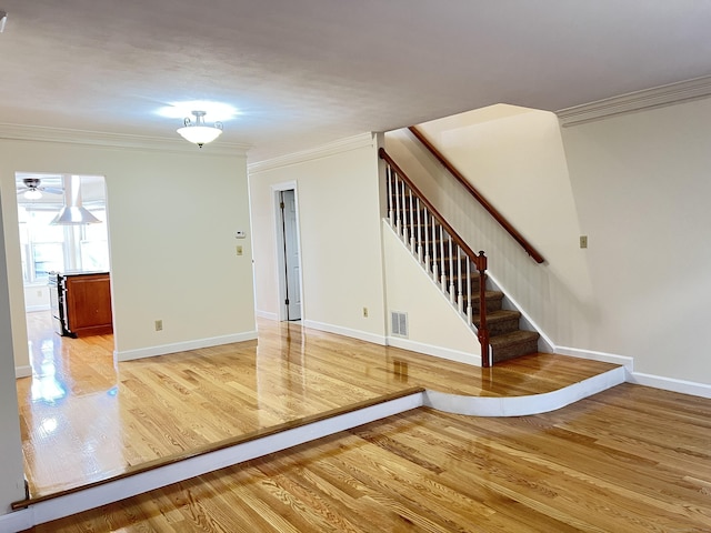 spare room with hardwood / wood-style flooring and ornamental molding