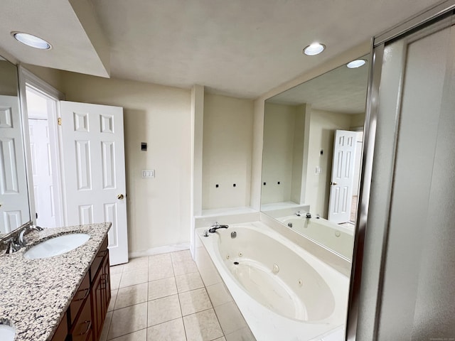 bathroom featuring tile patterned floors, tiled tub, and vanity