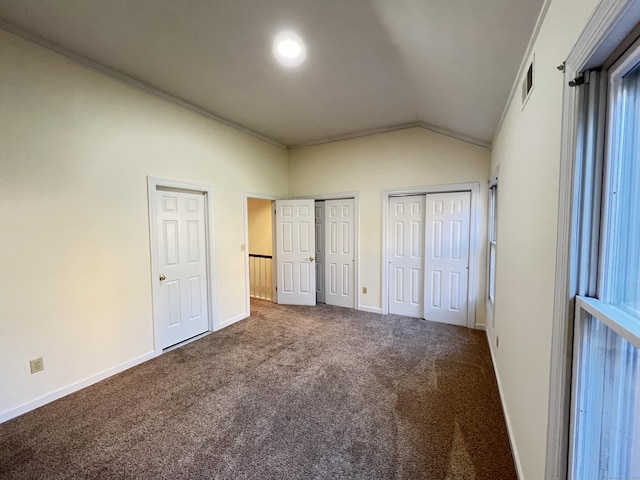 unfurnished bedroom featuring carpet and lofted ceiling