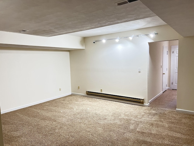 basement with a baseboard radiator and light colored carpet