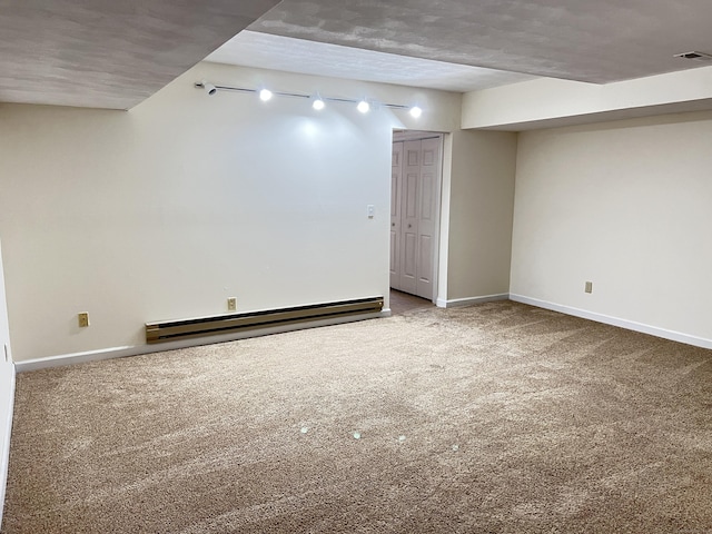 basement featuring carpet floors, a baseboard radiator, and a textured ceiling