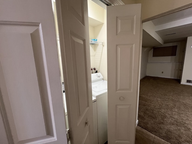 laundry area featuring carpet floors and washer / dryer