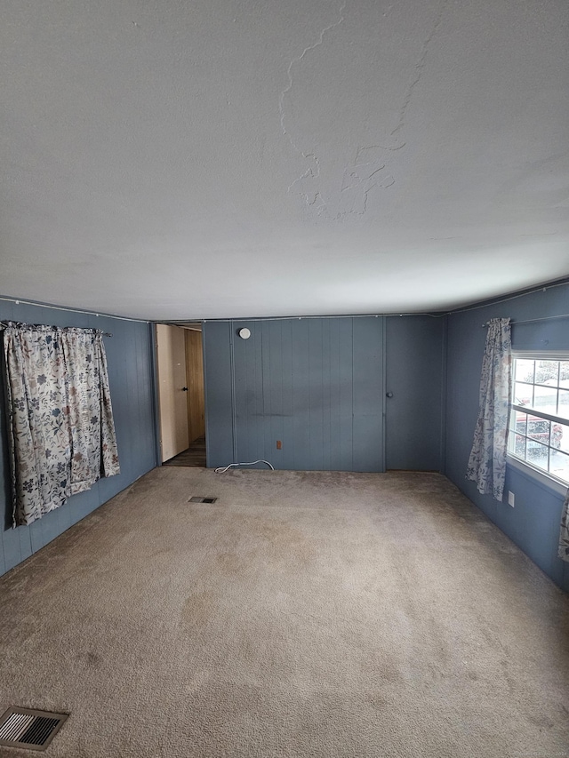 basement featuring carpet and a textured ceiling