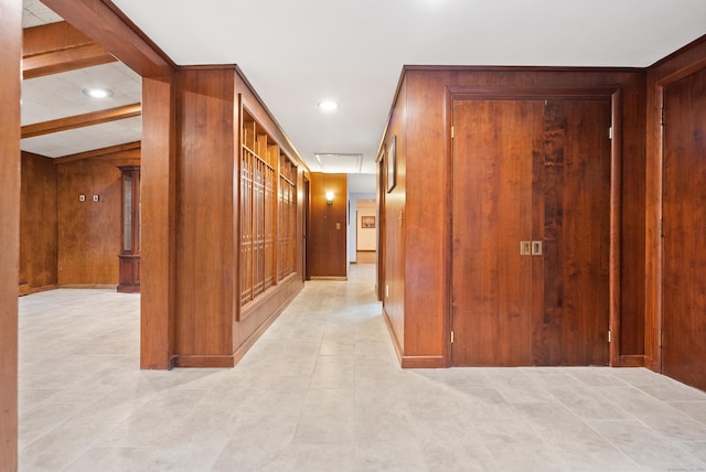 hallway featuring lofted ceiling with beams and wood walls