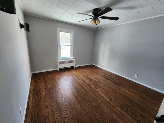 unfurnished room with dark hardwood / wood-style floors, ornamental molding, and radiator