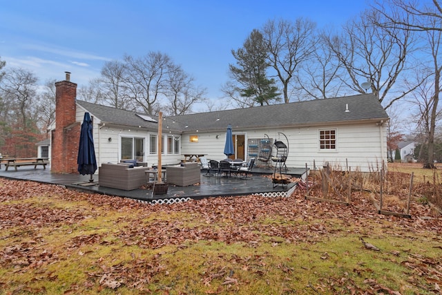 back of property featuring outdoor lounge area and a deck