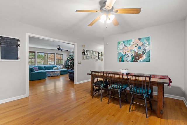 dining area with hardwood / wood-style floors and ceiling fan