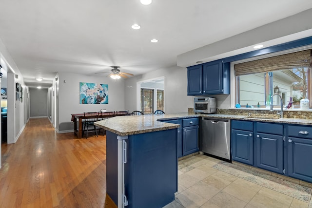 kitchen featuring sink, dishwasher, blue cabinets, kitchen peninsula, and light hardwood / wood-style floors