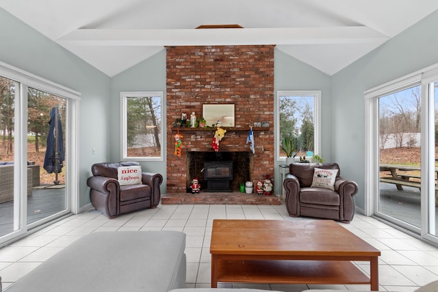 tiled living room featuring beam ceiling, a wood stove, and plenty of natural light