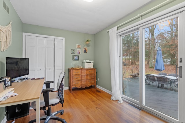 home office with hardwood / wood-style flooring