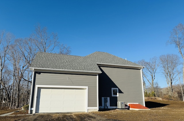 view of property exterior featuring central AC and a garage