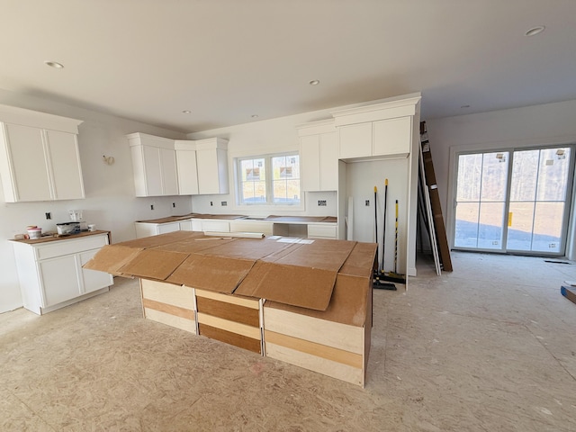 kitchen featuring white cabinets, white refrigerator, and a wealth of natural light