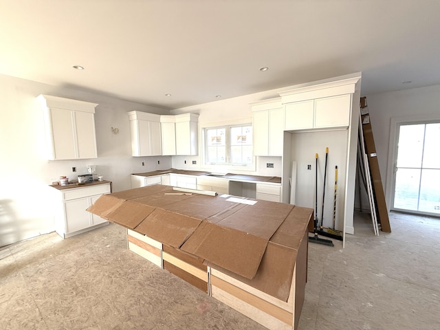 kitchen featuring white cabinets and a healthy amount of sunlight