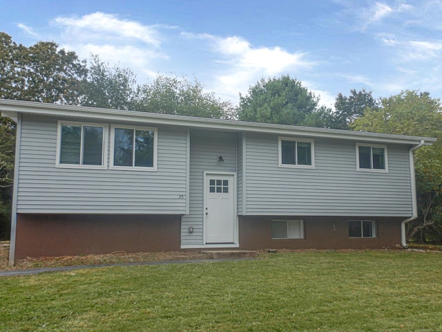 raised ranch with a front yard