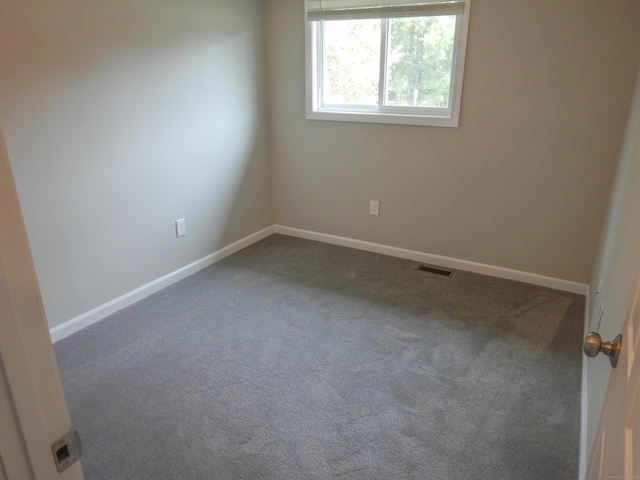 empty room with dark colored carpet