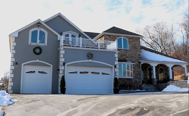 view of front facade featuring a balcony and a garage