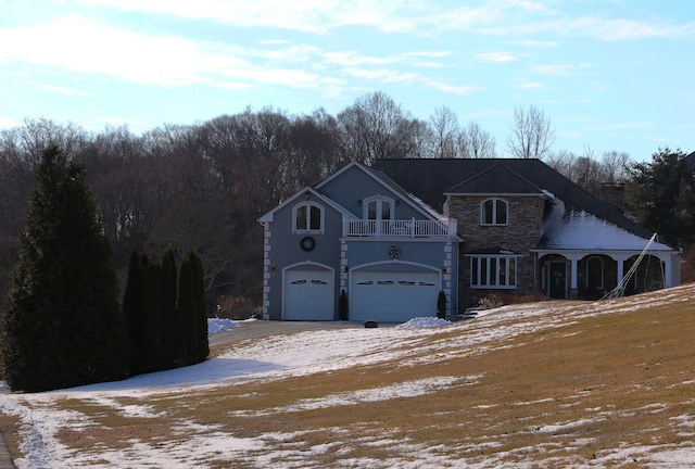 view of front property with a garage and a balcony